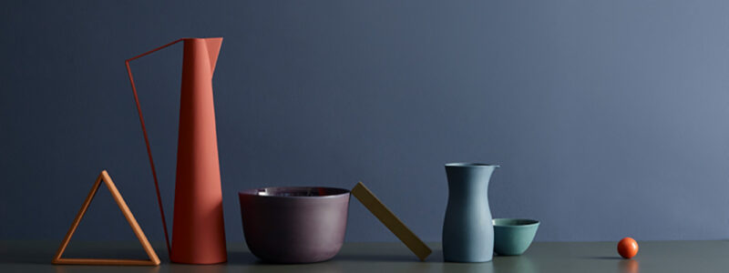 East facing rooms|Roughly painted wall with paper colour brush outs taped on.|Colour drops with an image of a dining and open kitchen in peach baby.|Green wall with a make shift table filled with pots of plants with the different colour drops on the right