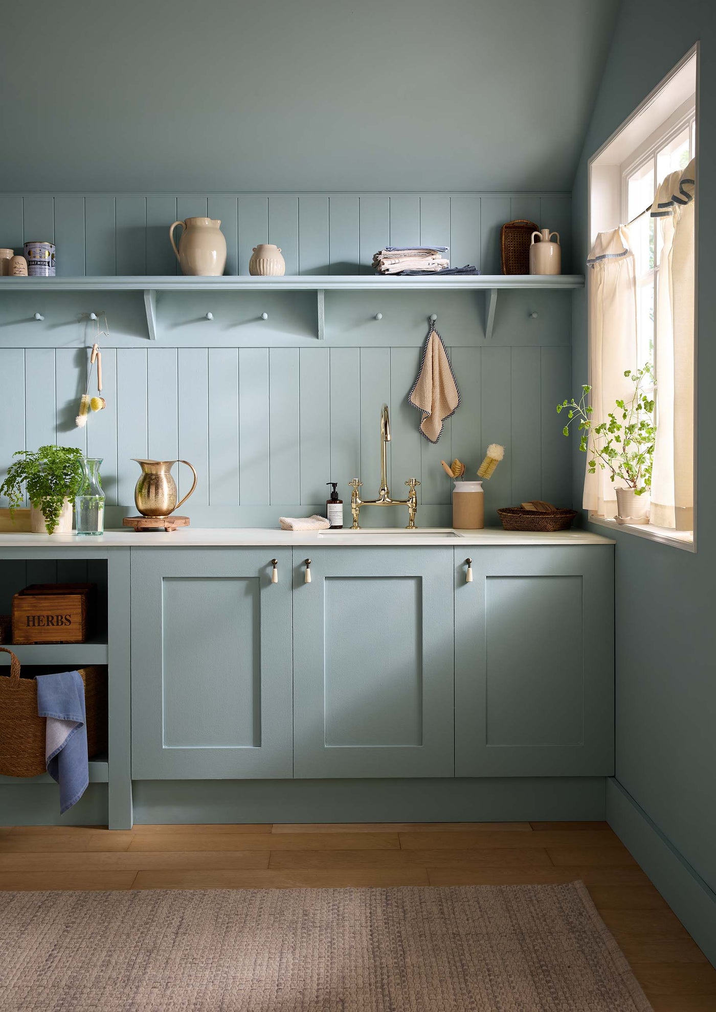 Modern kitchen with light blue cabinets and white countertops