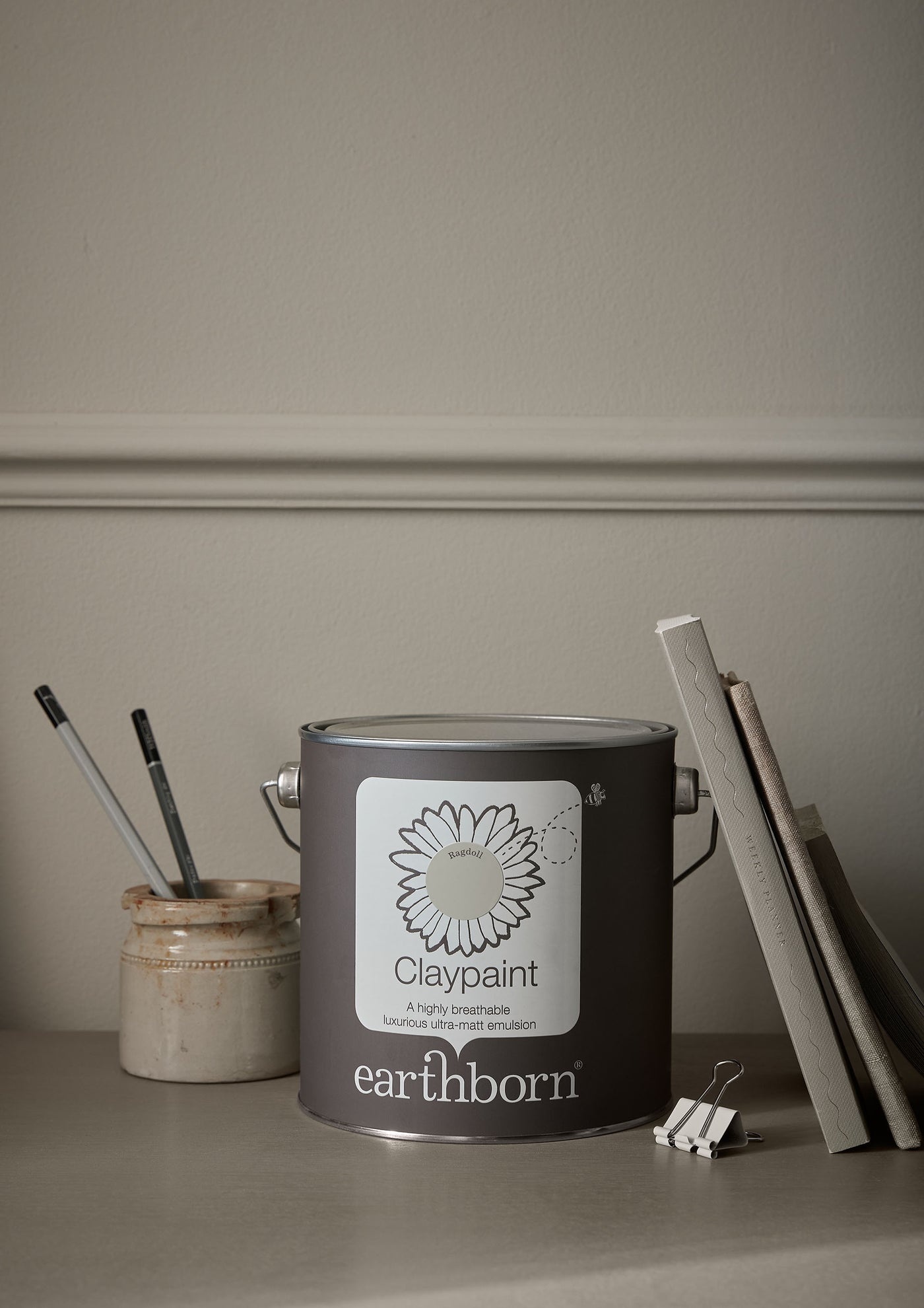 Earthborn Claypaint tin on a surface with a neutral background