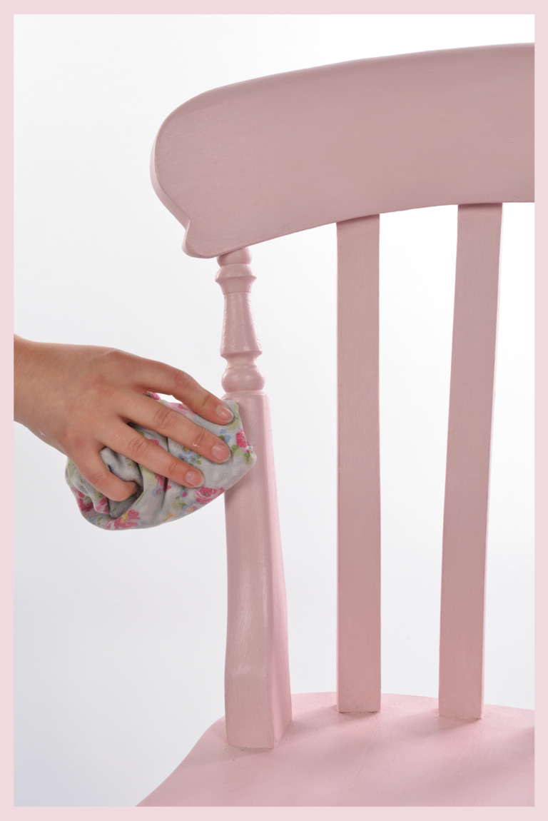 Buffing a painted chair with furniture wax.