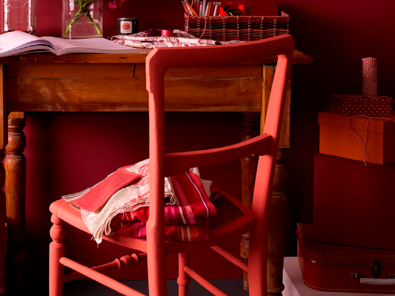 A bold painted chair using Earthborn Riding Hood, a warm red paint colour