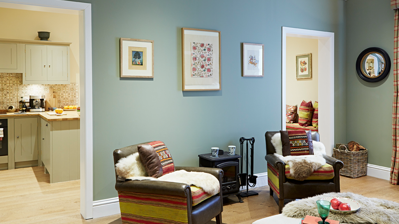 Warm paint colours like Earthborn's soft olive green Sunday Stroll are perfect for dark, north facing rooms 