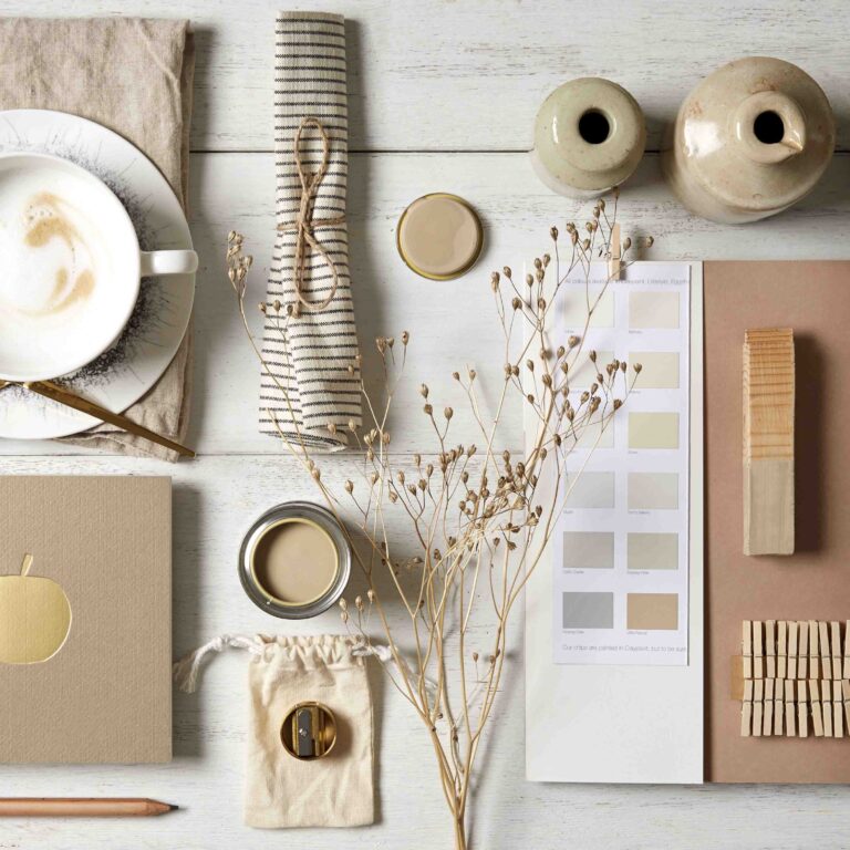 Neutral flat lay of different objects of a similar neutral tone to the sample paint pot of little rascal.