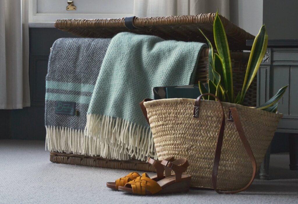 A basket of blankets beside the sofa makes your living room ready for a cosy night in