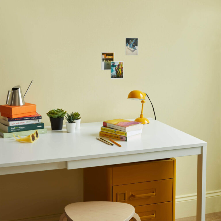 A desk set up with Sponge Cake on the wall.