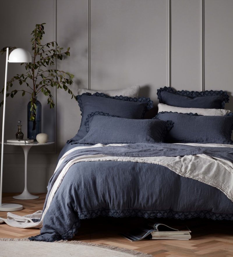 Warm grey paint colour Cat's Cradle looks wonderful paired with deep blue linen bedding