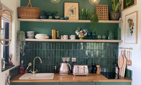 Kitchen nook with the wall and cabinets painted green.