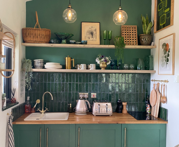 Kitchen nook with the wall and cabinets painted green.