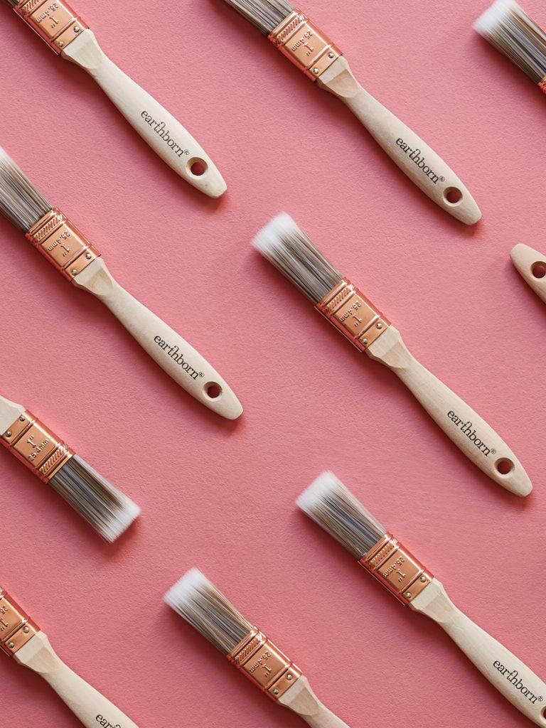 A pink background showing Earthborn paint brushes.