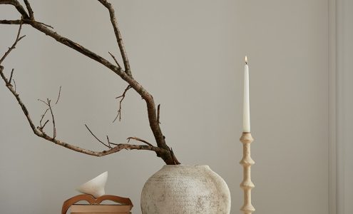 Candle and vase against a wall painted in Hopscotch.