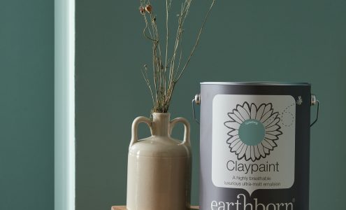 Splashing wall with paint tin.