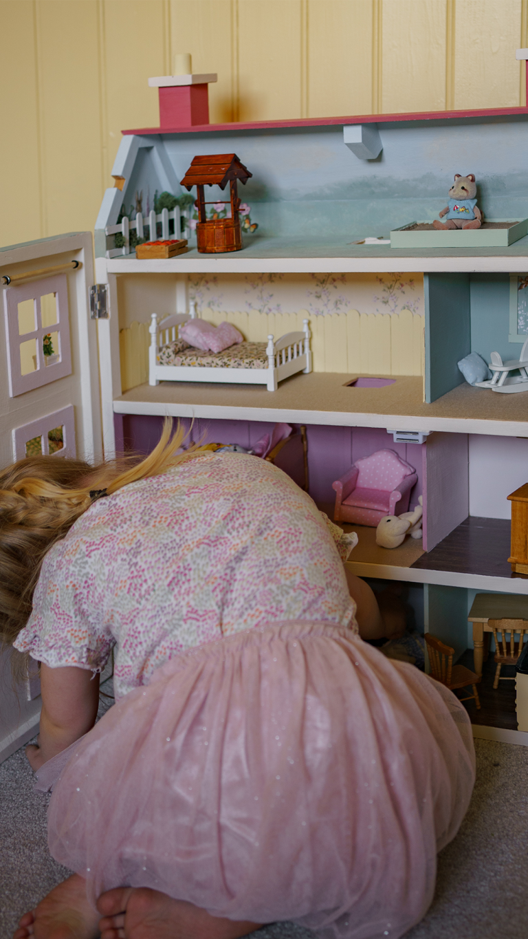 The painted inside of a doll house.