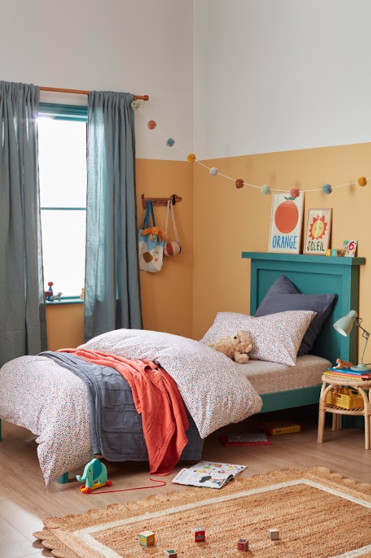 Bedroom with walls painted in Humpty Dumpty yellow paint, and Bed frame in Bobble Hat